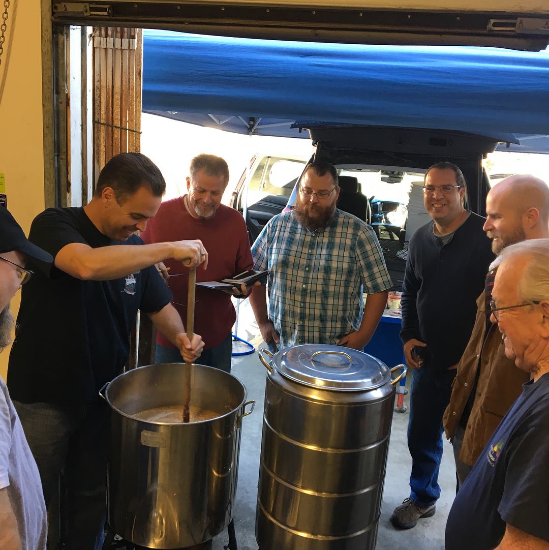 Brewing class people standing around a beer mash